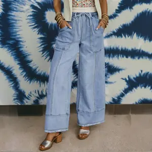 Women's drawstring high-waisted wide-leg denim pants with patch detailing, a large pocket, raw hem, and seam details—casual style for everyday wear
