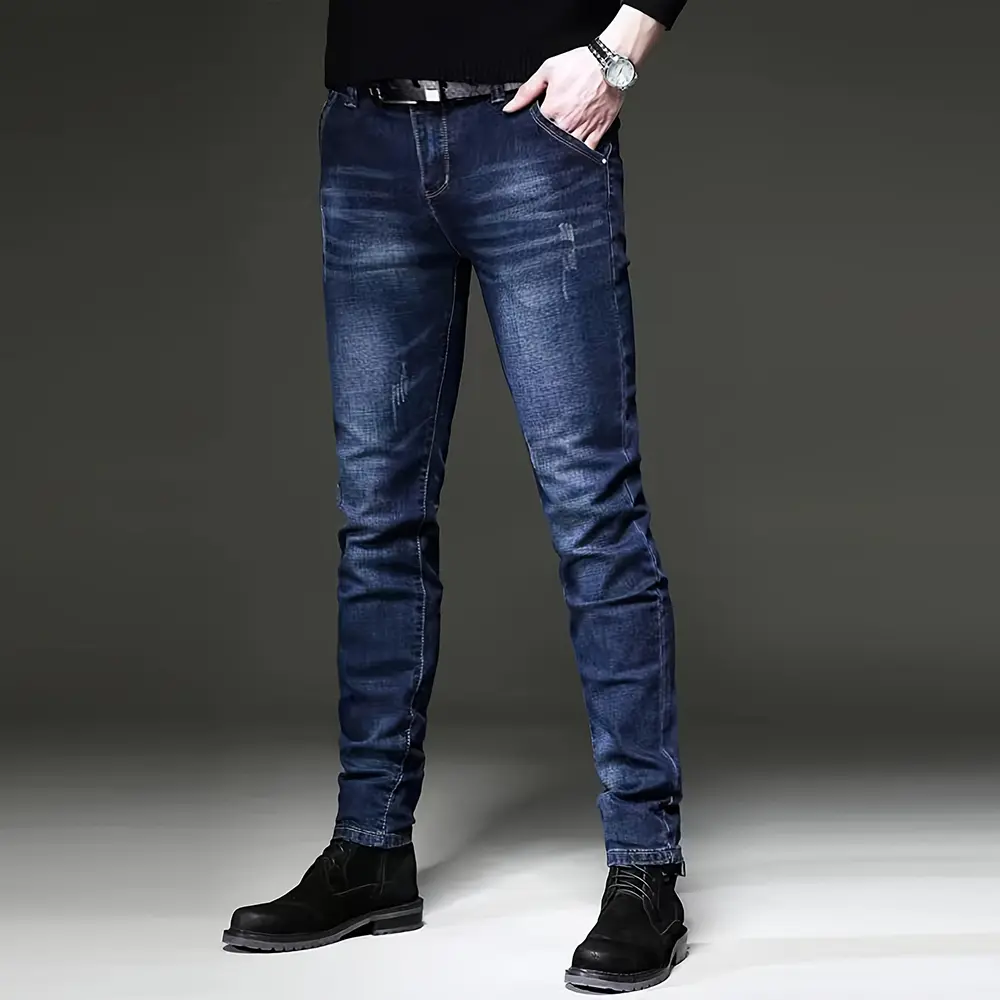 Men’s blue washed stretch denim jeans, slim fit tapered leg, solid color, minimalist casual long pants—versatile European and American trend jeans.