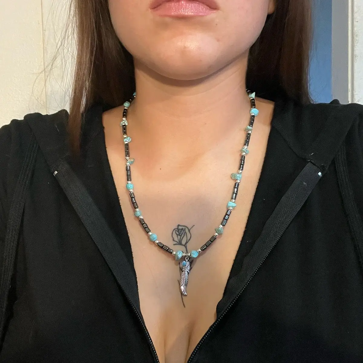 This Navajo handmade necklace and bracelet set consists of hematite, sterling silver beads, graduated turquoise beads, and a silver plated feather with waterwash turquoise as the centerpiece.