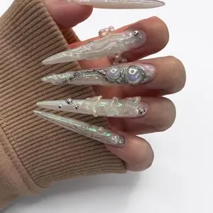 Elegant Pearl and Silver Nails with Intricate Designs for a Stunning Look