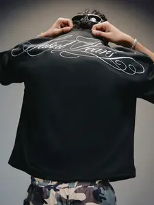 Minimalist Black Graphic Tee with Elegant Cursive Back Design - Luxury Feel Streetwear Shirt - Comfortable Loose Fit Casual Top for Daily Wear & Club Night Outfits, Menswear