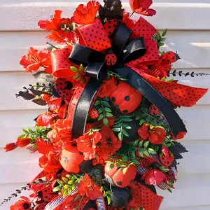 Ladybug Swag with red flowers, ladybug picks, and a black and red bow