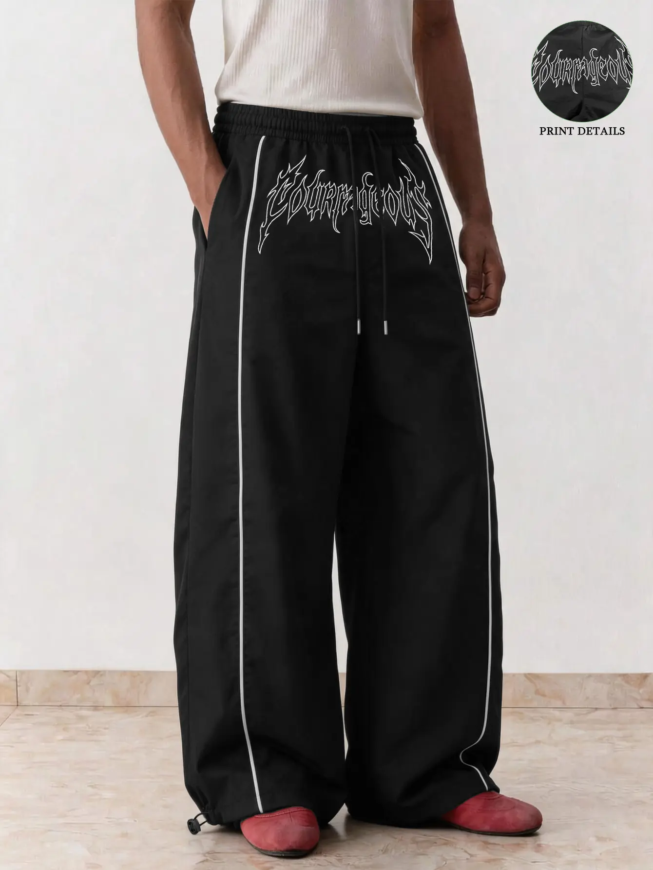 【Gothic-style letter print wide-leg casual long pants】 Unisex design with side white stripe detailing and an elastic waistband with drawstring; adjustable cuffs allow two ways to wear—loose straight-leg pants. Lightweight, smooth fabric with a high-street