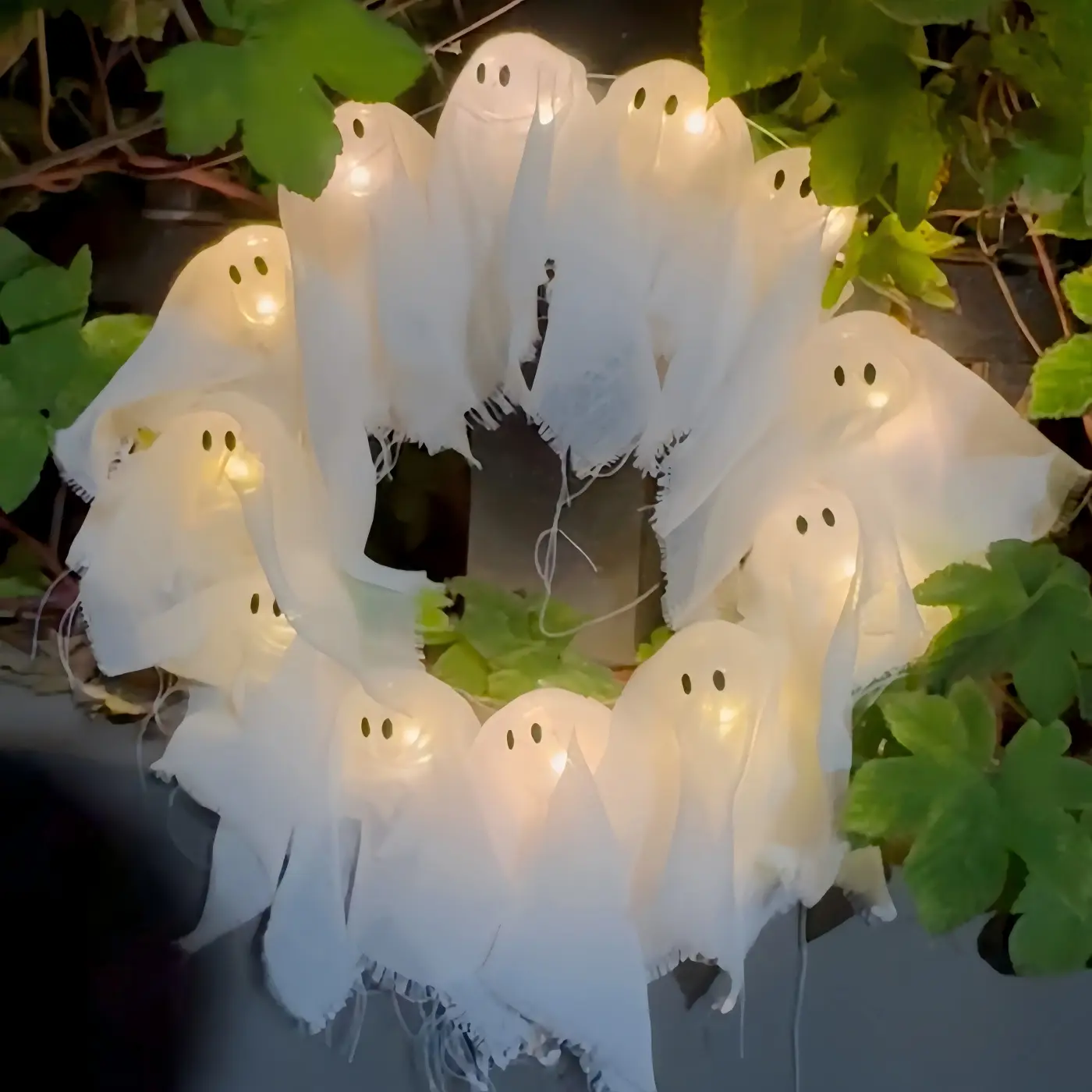 A Halloween glowing led lights ghost wreath, a Halloween ghost gang knocking on the door, a cute yet thrilling Halloween home door and window decoration pendant, a handicraft that easily creates a Halloween atmosphere