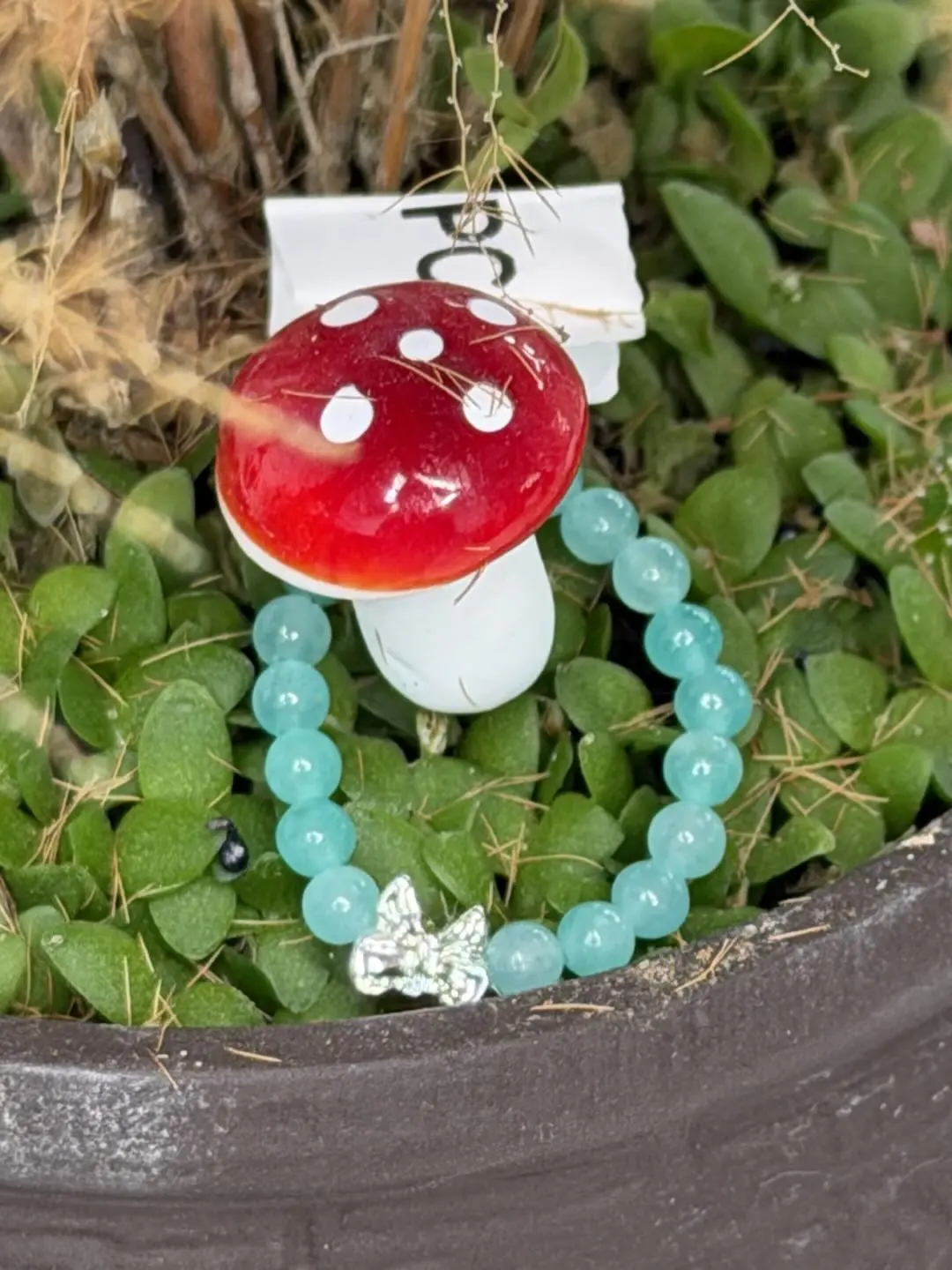 Yancy(18015)gc.This tiny elastic ring fits all finger sizes easily, gentle mint tone with shiny bow charm, sweet minimalist style, perfect for gifting.