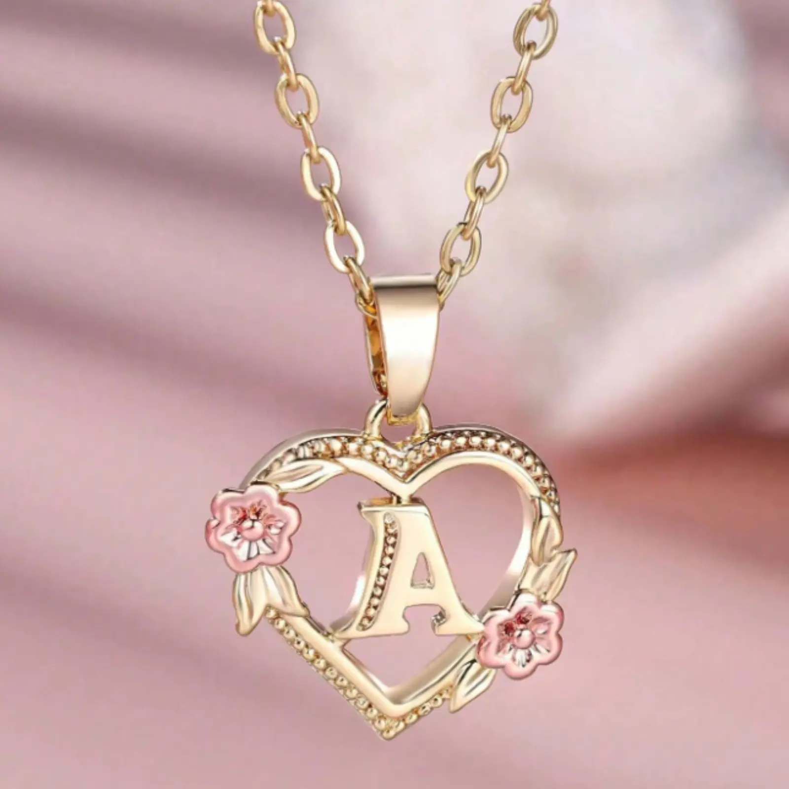 An exquisite 18k gold-plated necklace featuring initials, a heart-shaped pendant engraved with the 26 letters of the alphabet (A-Z), and flowers, suitable for everyday wear for women. Perfect as everyday jewelry or a gift.