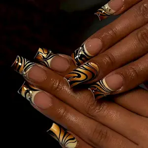 24 pcs square press on nails featuring a trendy European and American style Nail Art with tiger stripes glossy black and brown color blocking goose yellow accents champagne gold gemstones and irregular black stripes with a French tip nails design