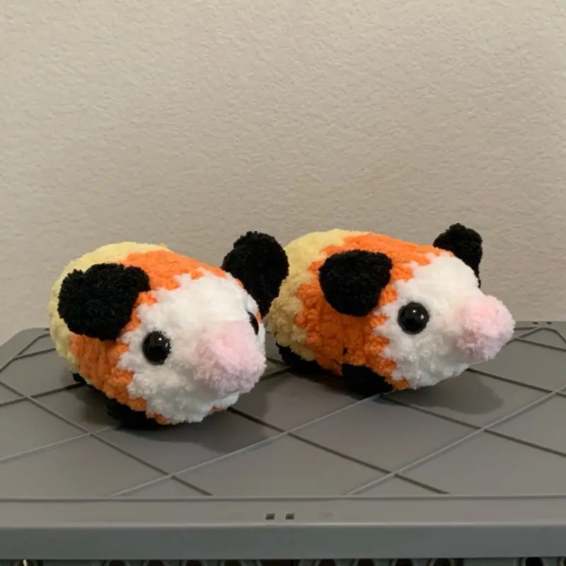 Hand crocheted candy corn opossums