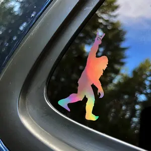 Sasquatch rockin' vinyl decal | Self-adhesive window sticker | Glossy finish | Cartoon gorilla silhouette with rock hand gesture | Durable and weatherproof | Ideal for car exteriors, vehicle decoration | Playful car accessory