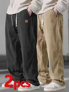Two men's casual pants featuring a simple and versatile style with drawstring design, adding a casual feel. The pants have delicate small details, making them full of texture. The loose fit provides comfortable and relaxed wear, suitable for everyday outi