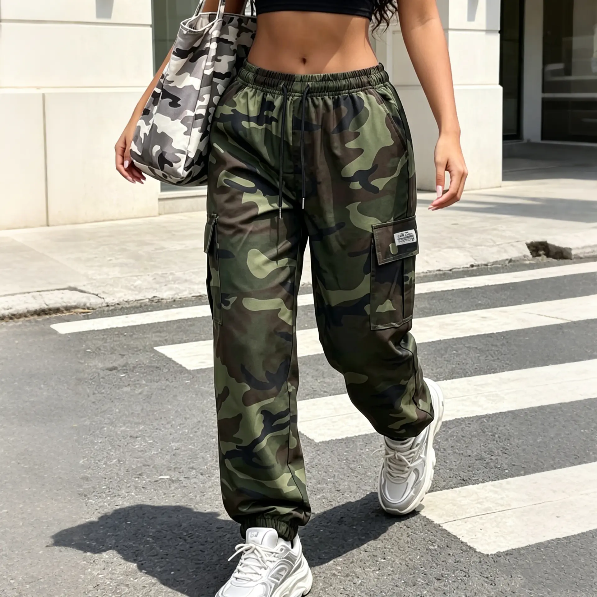 Spring/Summer women’s cargo pants, long length, army green camouflage. Casual multi-pocket military style with a drawstring design and elastic waistband. Comfortable, loose athletic pants suitable for everyday wear.