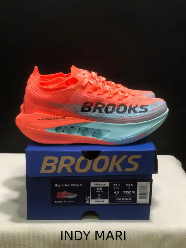 Marathon exclusive athletic shoes built with rigid carbon plate, vibrant orange blue color scheme creates trendy sport street daily matching outfits