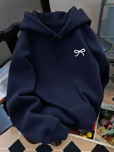 Soft fleece-lined, relaxed-fit graphic style with a bowknot, kangaroo pocket and adjustable drawstring hood. This on-trend hoodie sweatshirt pullover is perfect for versatile daily casual wear in fall and winter.