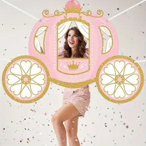 Princess's birthday celebration decorations, including a photo booth with a carriage theme and a party backdrop fabric
