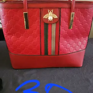 Red America Bee Leather Handbag with Gold Bee Charm Striped Accents and Elegant Design for Everyday Use