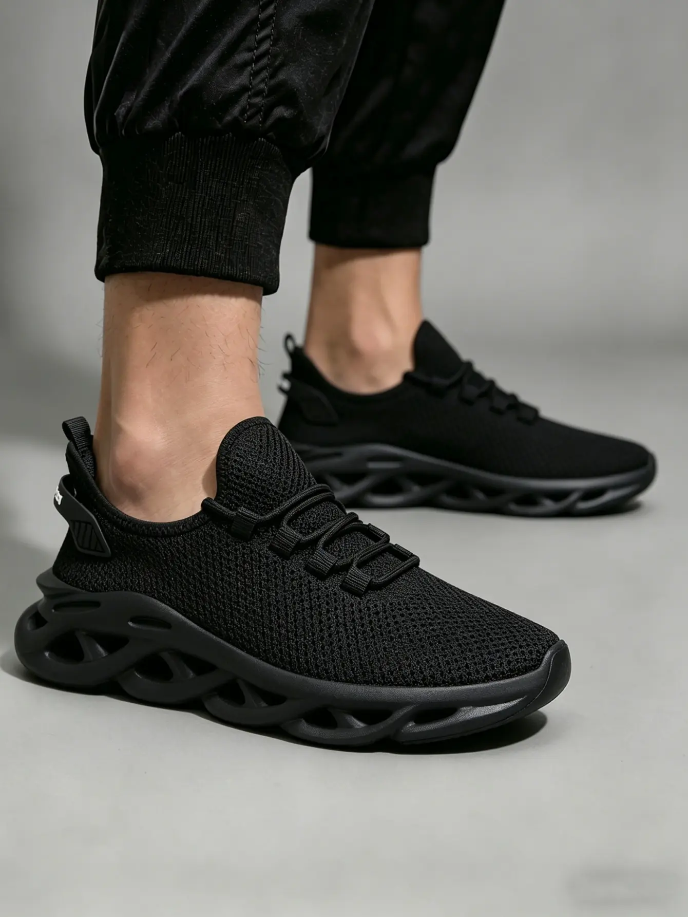 Male Sneaker in All-black Flyknit, Breathable Slip-on Trainers with a Cushioned Hollow Sole for Street Style and Daily Walk, Walking Shoes, Breathable Mesh Sneakers, Super Lightweight Sneakers