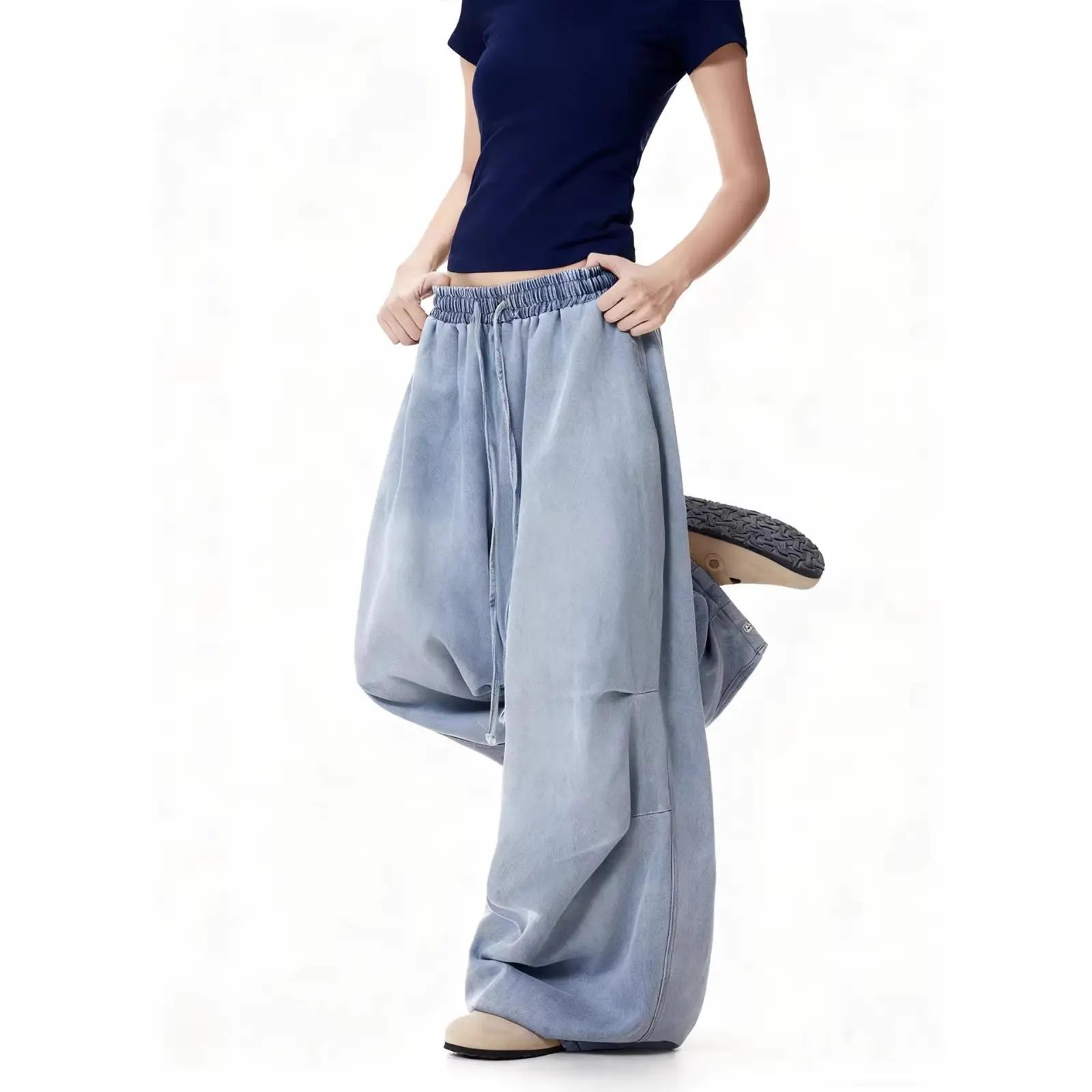 Women's light wash blue denim parachute pants, high-waisted with elastic drawstring and ruched detailing, wide-leg jeans, loose fit, plus size, Y2K street hip-hop style, soft vintage feel, everyday casual floor-length pants