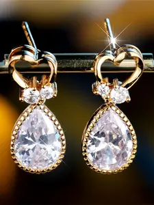 A pair of oval-shaped white zirconia ear studs, stylish and minimalist, perfect for wedding parties.