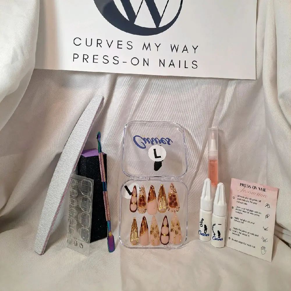 CMW’s (French Gold)10-piece long stiletto press-on nail set—featuring a soft nude base adorned with intricate gold details and warm caramel accents. Each nail radiates opulence, with sculpted gold patterns and a rich, sophisticated color palette