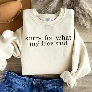 “Sorry For What My Face Said” sweatshirt, a sarcastic and funny crewneck perfect for everyday humor, great for anyone who loves playful, expressive statement apparel. - LORA ATCHER