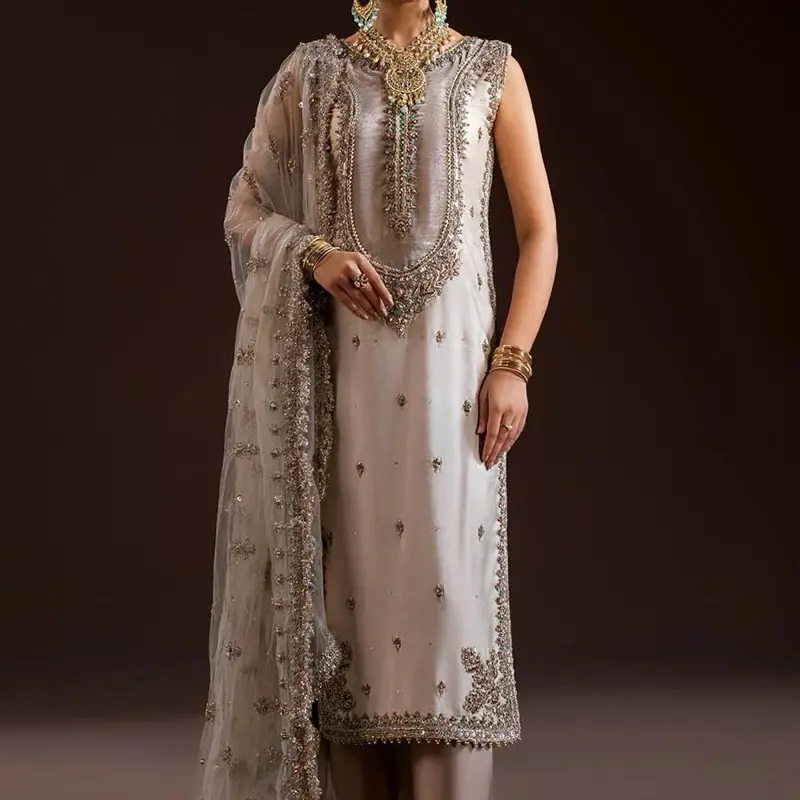 READY TO WEAR    What's Included: Shirt Sleeves Attached Inner Trousers (Elasticized waistband) Dupatta Fabric Details: Shirt: Pure glass silk (kora dabka zardozi work) Sleeves: Same as Shirt  Dupatta: Net Trousers: Pure Chermeuse Silk Disclaimer:  Produc