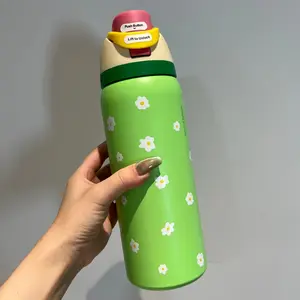 Owala Freesip pop-top insulated water bottle, with a green body and small daisy patterns, has a capacity of 32 ounces, is made of 304 stainless steel, features a double-wall design, and comes with a straw.