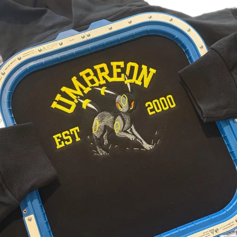 Embroidered Varsity Umbreon Hoodie, Crewnecks & Tees – Premium Quality, Custom High-Detail Designs, Trendy Apparel