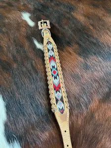 Genuine leather dog collar with red, white, and black southwest beaded inlay design, a leather wrapped edge