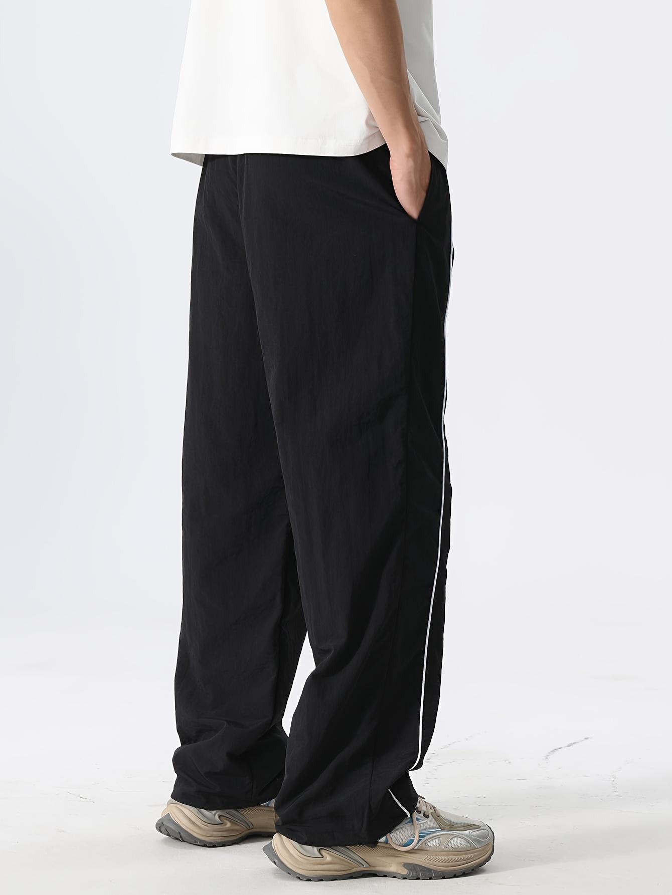 Men’s fashion loose fit long pants with side stripe paneling, drawstring waist, and elastic cuffs—perfect for everyday casual wear.