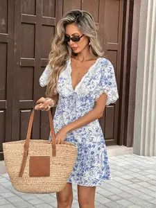 A resort-style blue-and-white floral mini dress with delicate lace trim. Ideal for seaside getaways, city strolls, brunch dates, weekend markets and other casual relaxed occasions.