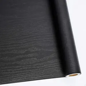 A roll of black wood grain stickers, wood texture, waterproof and oil-proof vinyl film, suitable for kitchen, bathroom, furniture renovation, easy to paste and remove, modern hollow pattern, semi-gloss, self-adhesive, reusable PVC material