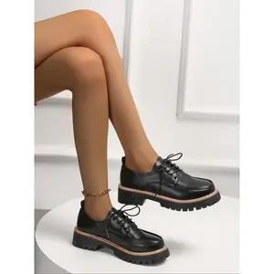 A pair of fashionable and versatile women's British style patent leather round-toe platform thick-soled loafers. Deep heel design with comfortable lace-up closure. Stylish and casual women's shoes for daily wear.