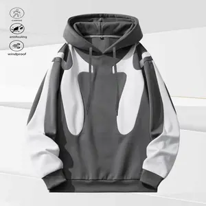A hoodie with patchwork style leaning more towards fashion streetwear. Overall, it features a gray color scheme with black accent design. The unique patchwork shape adds a stylish and visually impactful element. The hooded design enhances the casual and r
