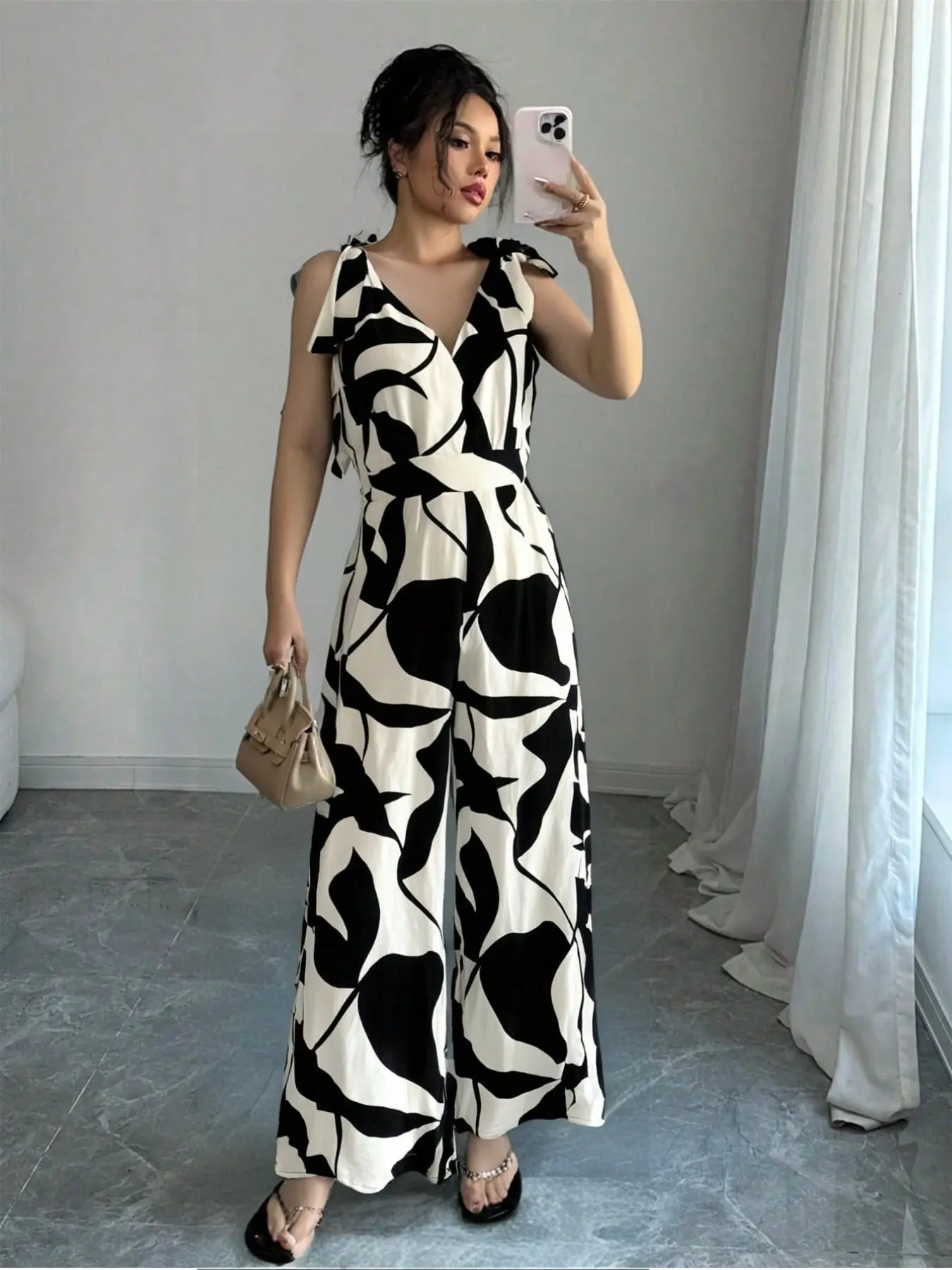 Spicy Coquette Black & White Abstract Print V-Neck Sleeveless Bow Strap Waist-Cinched Wide Leg Jumpsuit Vintage French Black & White Abstract Art Print V-Neck Sleeveless Wide Leg Jumpsuit