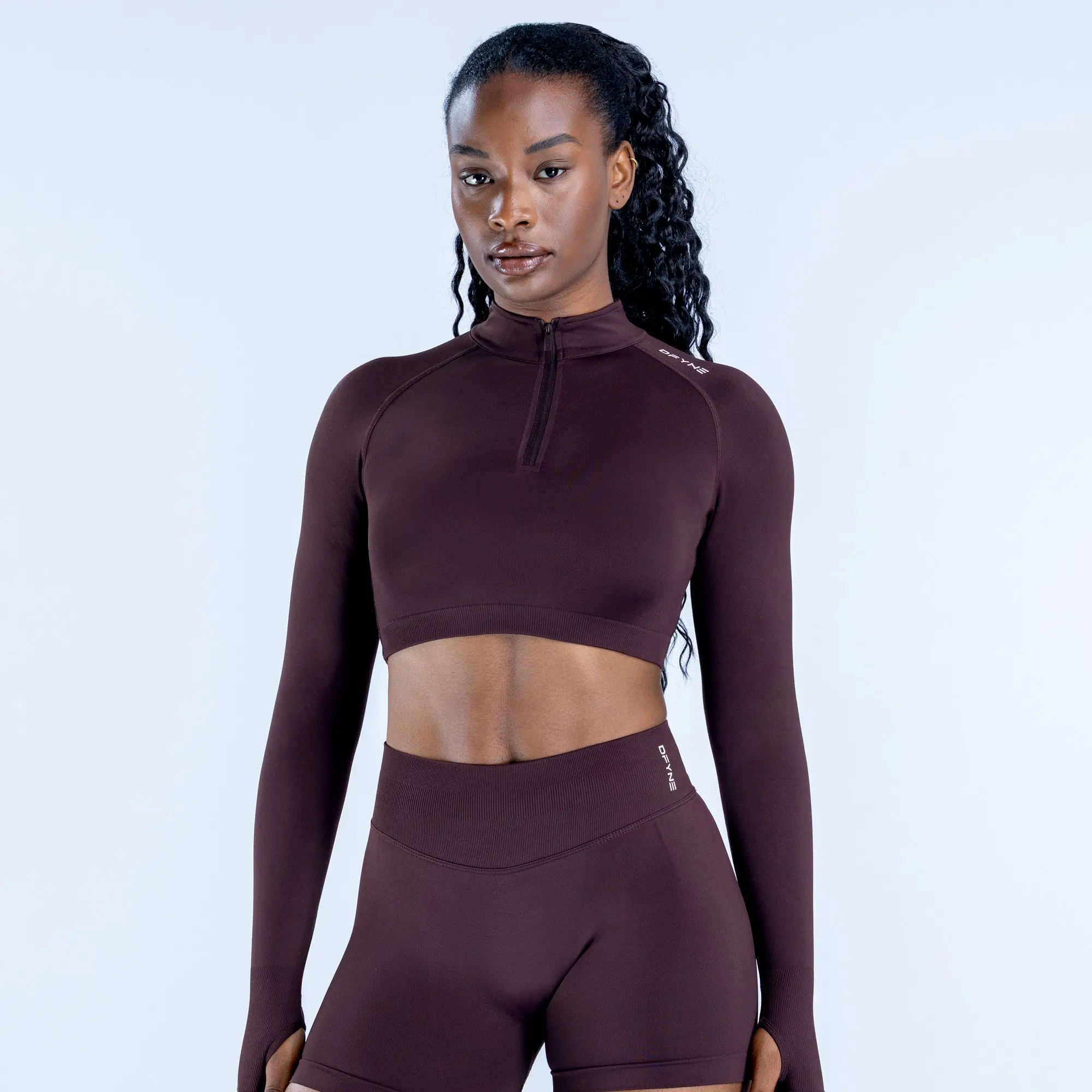 DFYNE half-zip cropped long-sleeved top, moderately thick and breathable with stretch, looks great worn alone or layered.