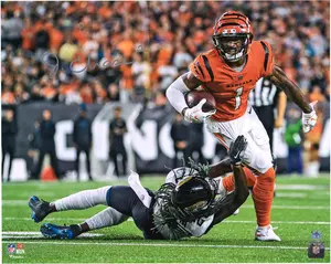 Ja'Marr Chase Cincinnati Bengals Autographed 16" x 20" Orange Breaking Tackle Photograph - Fanatics Authentic Certified