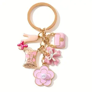 A Cute And Compact Pink Bag with a Heart-Shaped Oil Drop Keychain, Perfect As a Mini Decorative Accessory Or Gift for Cosmetics