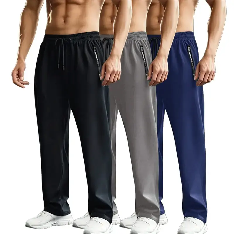Set of three solid-color men’s straight-leg casual pants with side branding; urban relaxed style. Elastic waistband with black drawstring for adjustable fit. Ice silk fabric is smooth and drapes with a cooling feel; loose straight cut that flatters leg sh