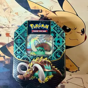 Pokémon Paldean Fates Tin – Iron Treads or Great Tusk (4 Booster Packs) – Factory Sealed