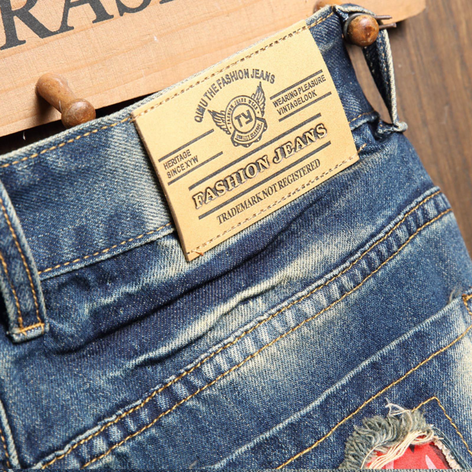 Bleached distressed denim mid-rise shorts with no stretch, multiple rips, raw hem, red-edge print lining—trendy five-inch inseam