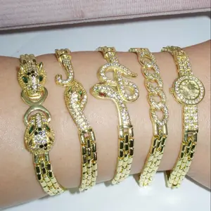 Elegant Gold-Tone Bracelets with Sparkling Animal Heads Green Stone Accents Snake-Inspired Shapes Classic Chain Motif Round Pavé-Style Medallion