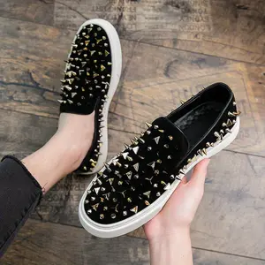 Men's slip-on loafers with gold studs. These edgy casual shoes feature a cushioned rubber sole and faux leather patches. Perfect with casual wear, vintage shoes, comfortable slip-ons, and bold shoe designs.