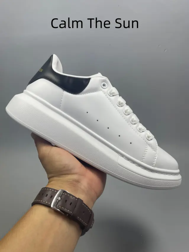 This timeless white leather athletic shoe with black heel counter features thick layered cushioned platform sole and smooth full-grain upper, matching all casual fits for campus, street outings, shopping and unisex daily all-season styling.