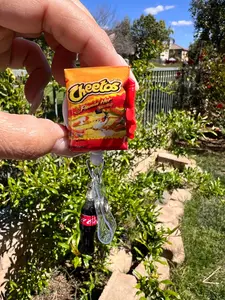 Hot Cheetos Badge Reel with soda
