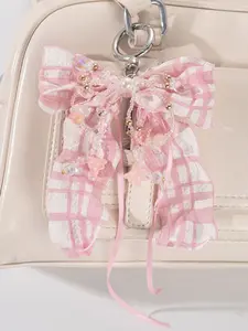 Sweet and fashionable pink and white checkered bow pendant, adorned with beads and bell orchids, featuring a niche design and retro personality, Fashion Bag Charms suitable for all kinds of bags, with a gentle and exquisite style