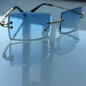 ICY Sunglasses es - Blue Tinted Lenses with Gold-Tone Frames for Stylish Protection