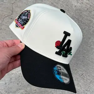 New Era LA Dodgers 9FORY Rose Hat – White And Black Adjustable Curved Brim Cap Featuring Floral LA Logo, Vintage Side Patch And Streetwear Fashion Design
