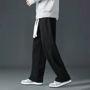 A pair of men's corduroy wide leg casual pants, featuring a stylish casual design with an adjustable drawstring at the waist for added comfort. The corduroy fabric is of good quality, with clear vertical stripe texture, showcasing a unique fashion taste.
