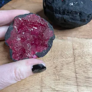 Red dyed uncracked geode with natural cluster interior