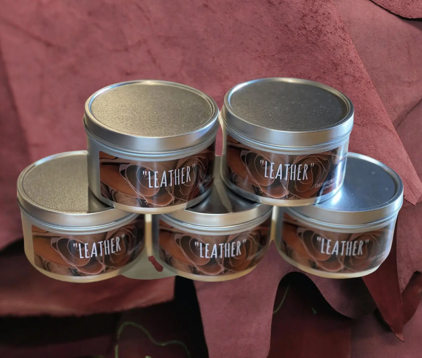 Leather Scented Candle. The candle is 100% soy wax and is in a 8oz tin container. the label is metallic. This is a 100% USA made product from Crafty American